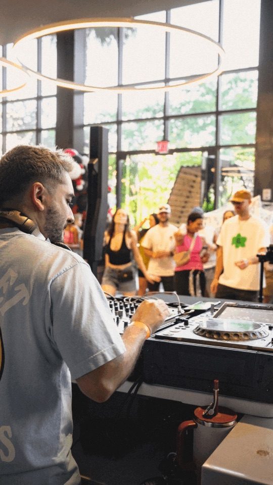 DJ performing on the decks at a Club Lumen event