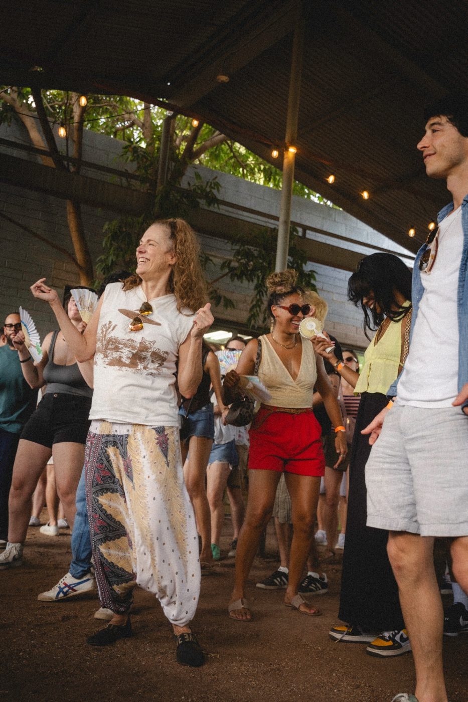 Guests dancing together outdoors at a Club Lumen Morning Rave